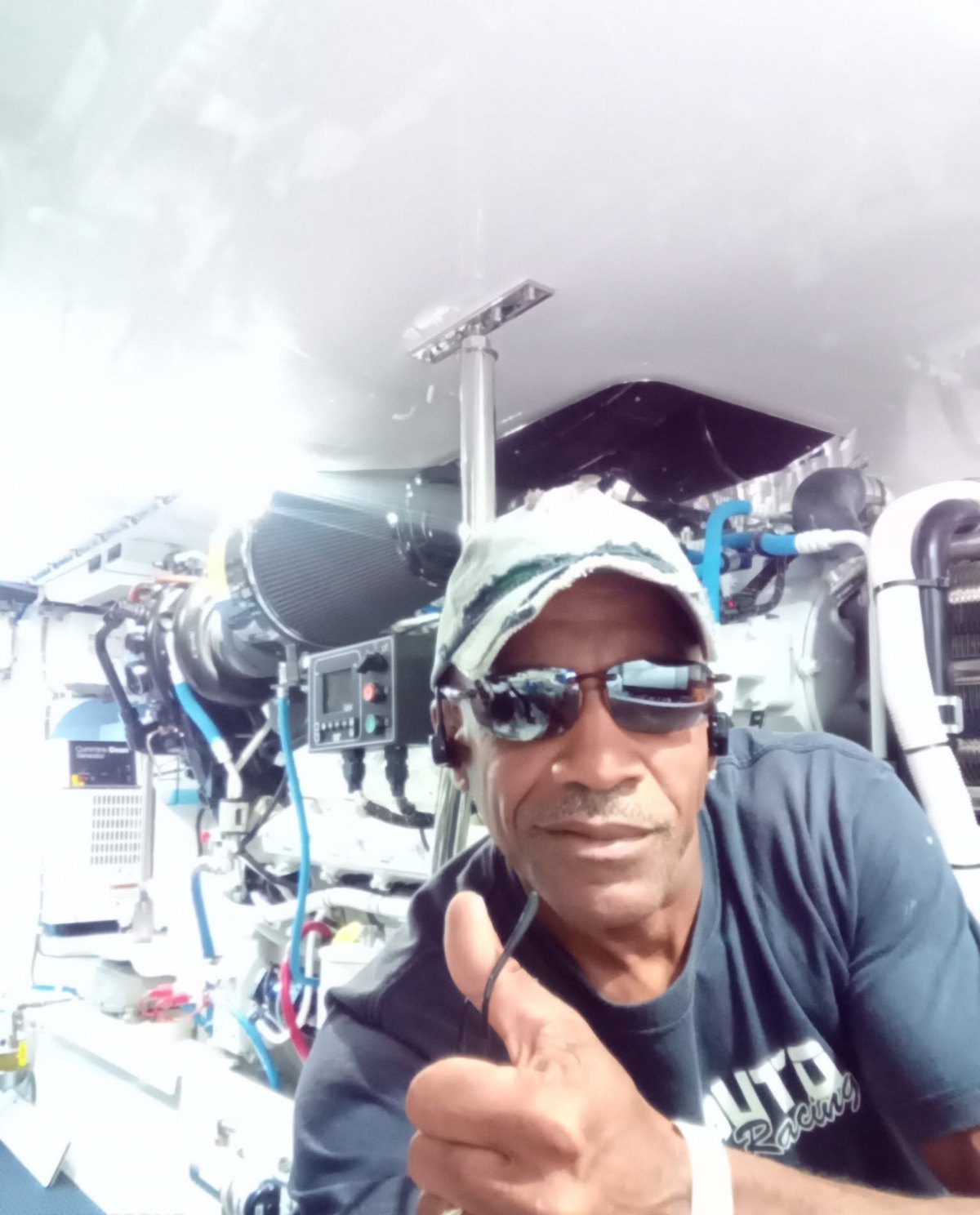 Capt. Troy Benn at work in an engine room alongside a marine generator set